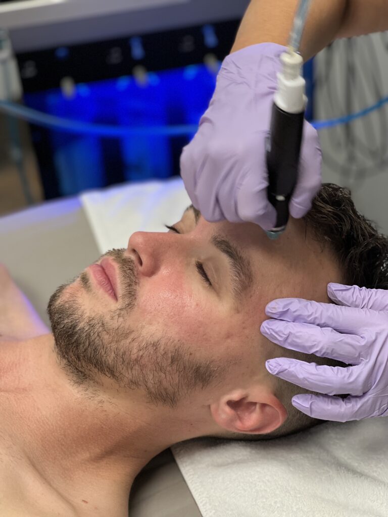 Close up of man with HydraFacial applicator on face