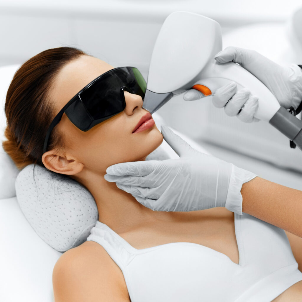 Woman receiving laser hair removal treatment on face