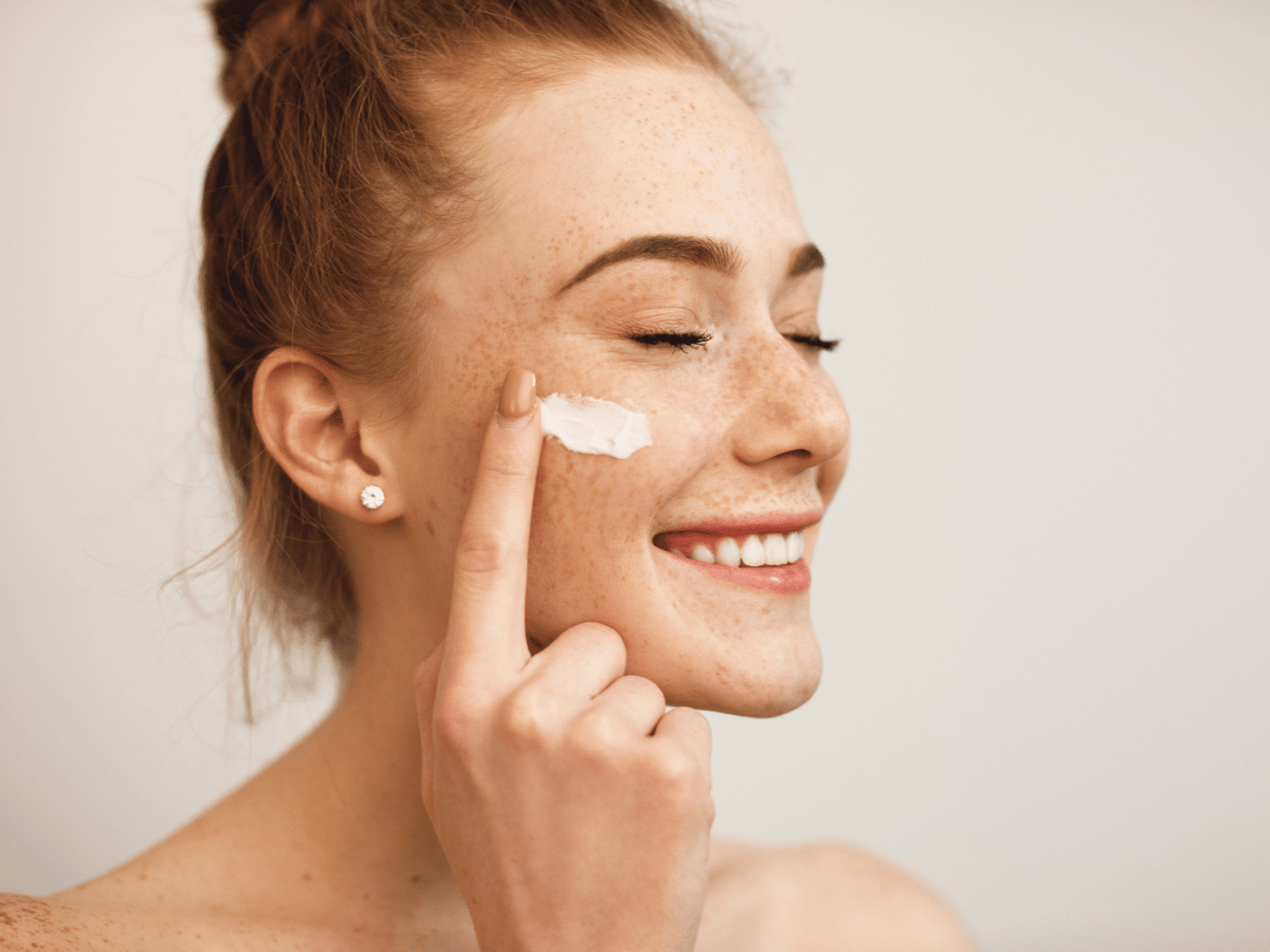 woman applying product to her face