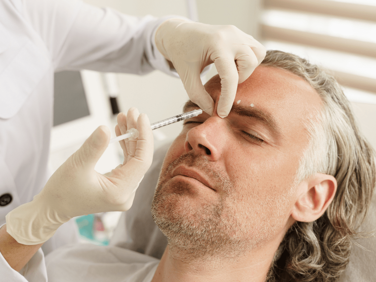 man getting injections in his forehead